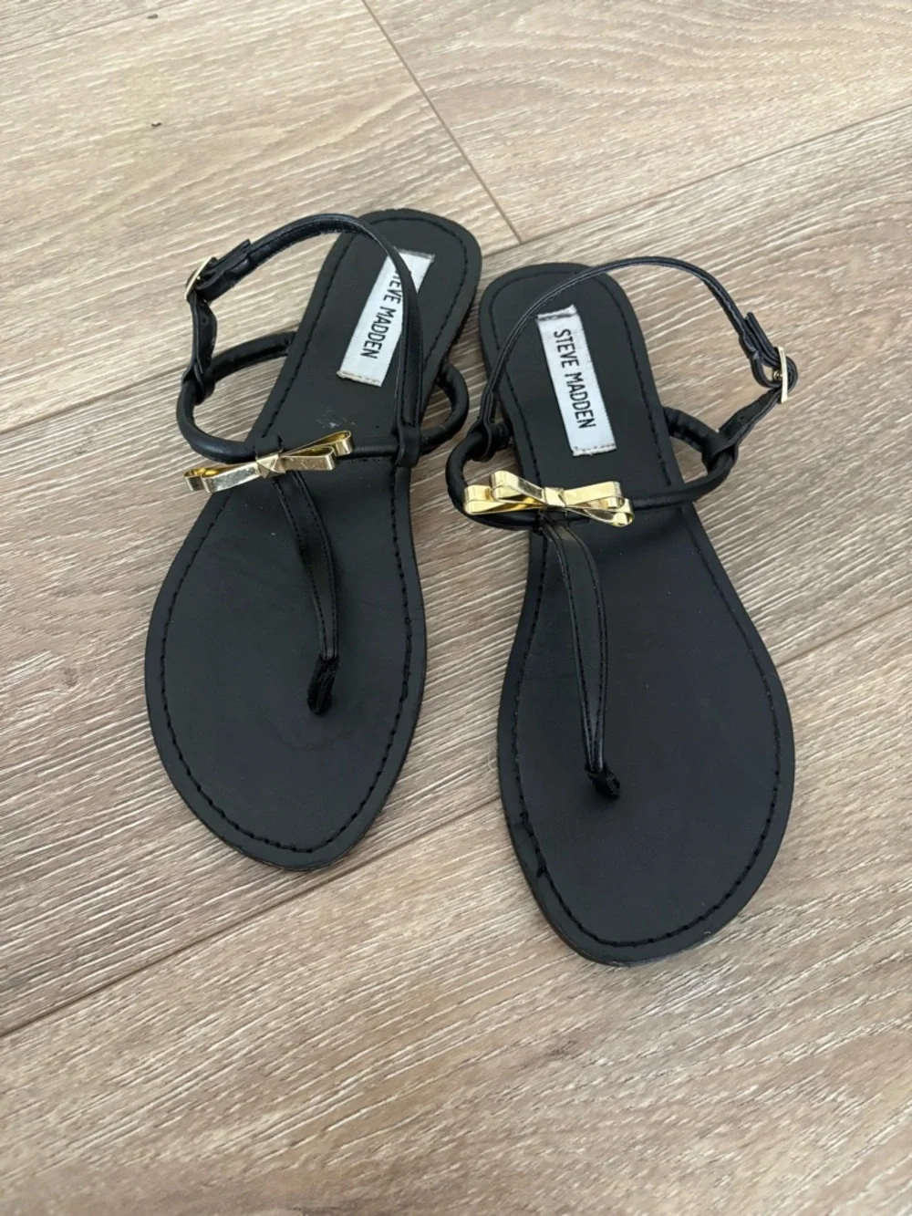 Steve Madden Black T-Strap Sandals with Gold Bow Accent